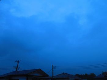 Low angle view of silhouette roof against sky