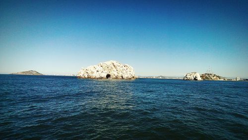 Scenic view of sea against blue sky