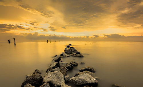 Scenic view of sea against cloudy sky