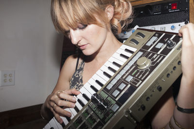 Young female musician playing a keyboard