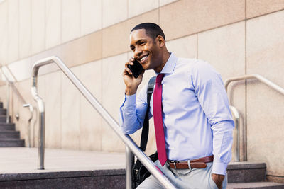 Side view of man using mobile phone