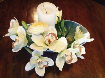 High angle view of white roses in vase on table