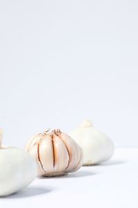 Close-up of bread on table against white background