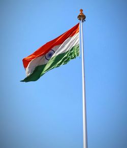 Low angle view of indian flag against clear blue sky