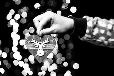 Cropped hand of woman holding christmas decoration