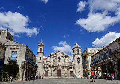 Group of people in front of building against sky