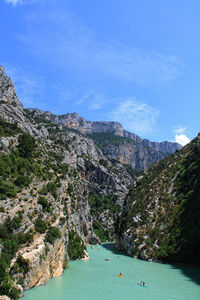 Scenic view of sea and mountains against sky