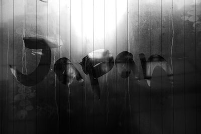 Digital composite image of people on glass window