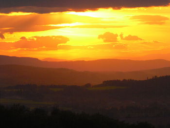 Scenic view of silhouette mountains against sky during sunset