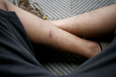 Midsection of man sitting in park