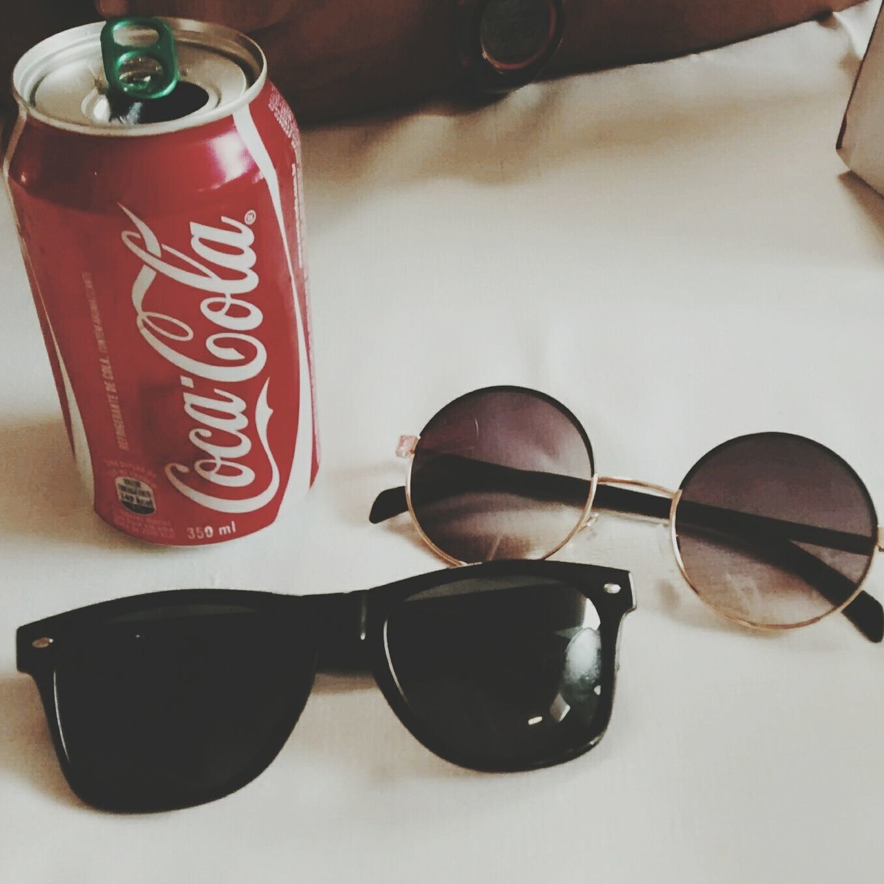 indoors, table, still life, coffee cup, drink, food and drink, close-up, high angle view, communication, cup, coffee - drink, refreshment, technology, no people, coffee, text, tea cup, red, western script, sunglasses