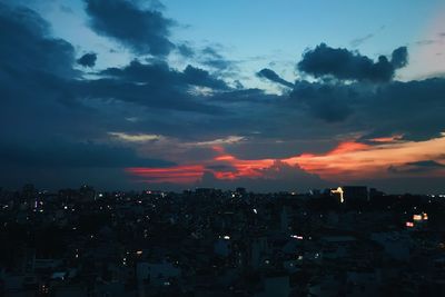 High angle view of illuminated buildings against sky at sunset