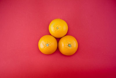Close-up of oranges against red background