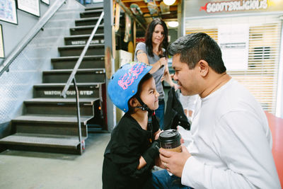 Father and son stare at each other while son makes a silly face