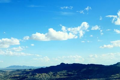 Scenic view of mountains against cloudy sky