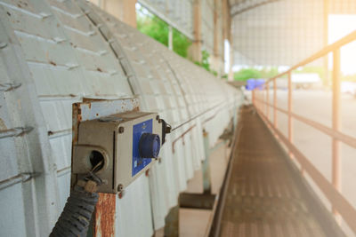 Close-up of camera on railing against building