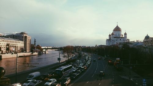 Buildings in city against cloudy sky