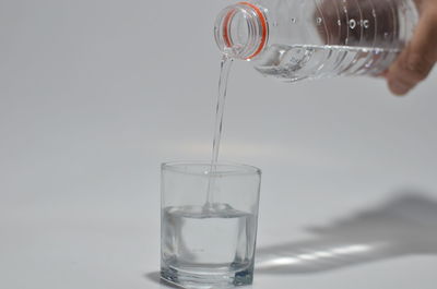 Reflection of person in glass drinking water