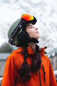 Side view of man wearing hat standing against sky