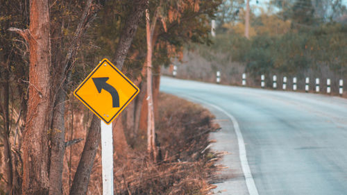 Road sign by trees