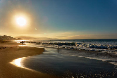 Scenic view of beach against sky during sunset