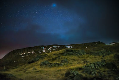 Scenic view of mountain against sky at night