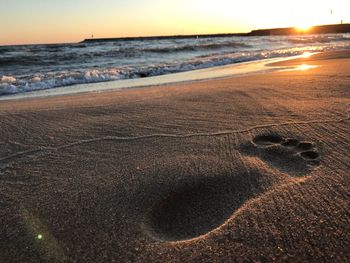 Scenic view of beach against sky during sunset