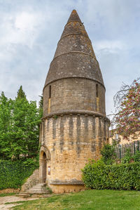 Low angle view of historical building against cloudy sky