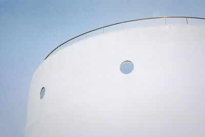 Low angle view of white water against clear blue sky