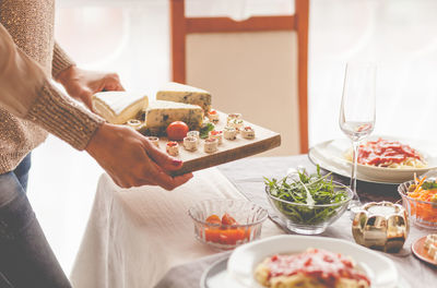 Midsection of woman keeping food on table