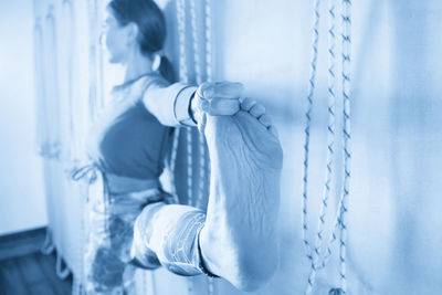 Low section of woman exercising at home