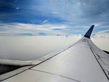 Airplane wing against sky