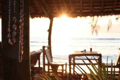 Close-up of balcony at beach against sky during sunset