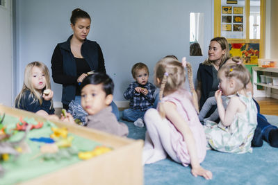 Teachers with children in playschool