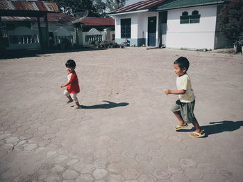 Full length of friends on street in city