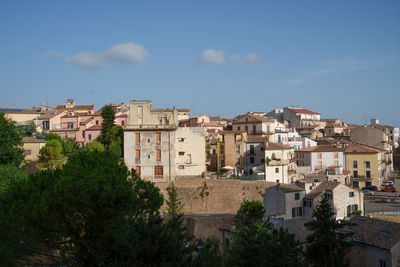 Buildings in town against sky