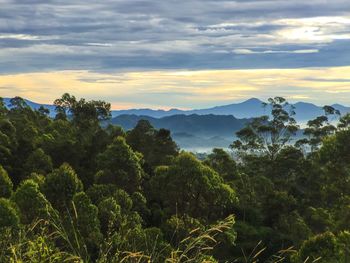 Scenic view of mountains against cloudy sky