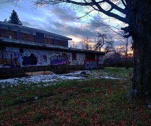 Graffiti on abandoned building against sky