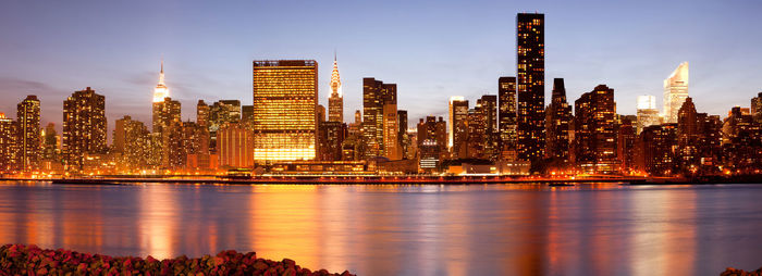 Illuminated city at waterfront