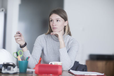 Young woman with long hair learning at home