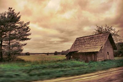 Rural landscape against cloudy sky