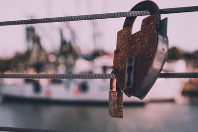 Close-up of padlocks on metal railing