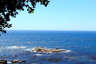 Scenic view of sea against clear blue sky