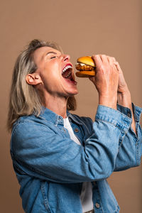 Side view of senior man smoking cigarette