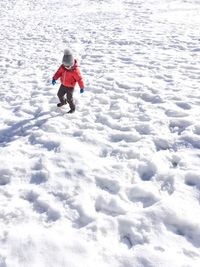 Full length of boy standing on snow field