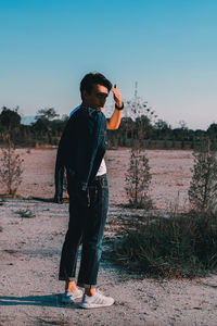 Full length of man photographing at camera