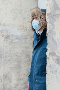 Man looking away while standing outdoors