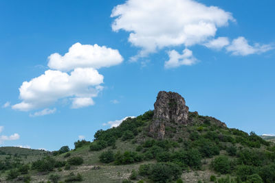 Low angle view of rock formation against sky