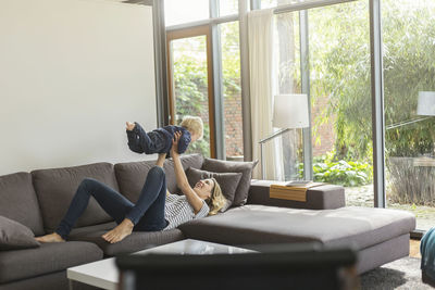 Mother and son at home playing on couch