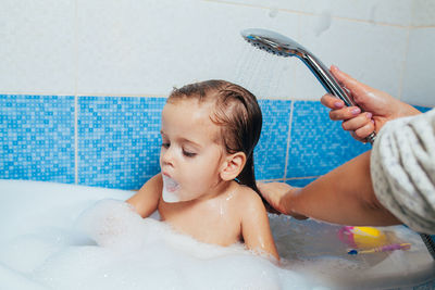 High angle view of shirtless boy in bathroom at home